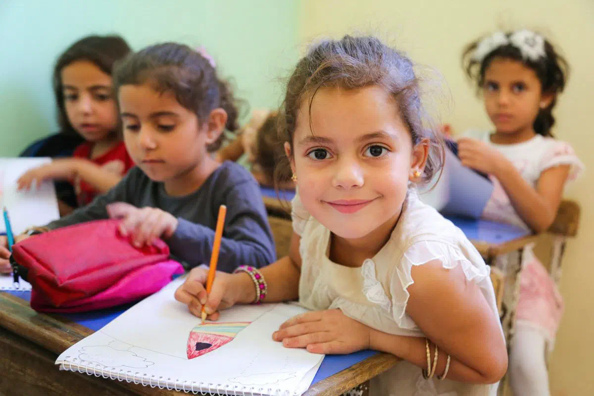 Elementary students working at their desks in an enrichment class